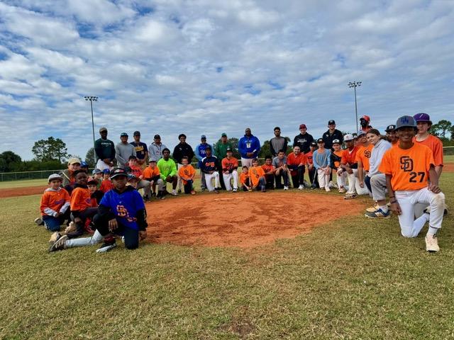Young players running fielding drills at an inclusive baseball clinic