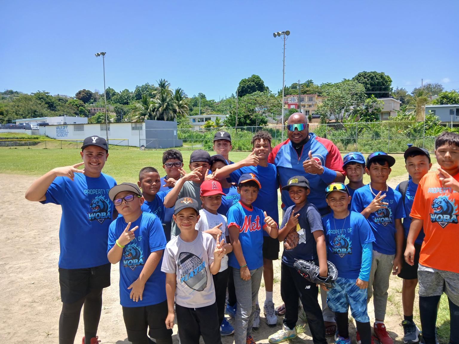 Coach K. Ross with a youth baseball team during a clinic in Puerto Rico